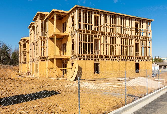 a snapshot of temporary chain link fences protecting a large construction project from unauthorized access in Cuero